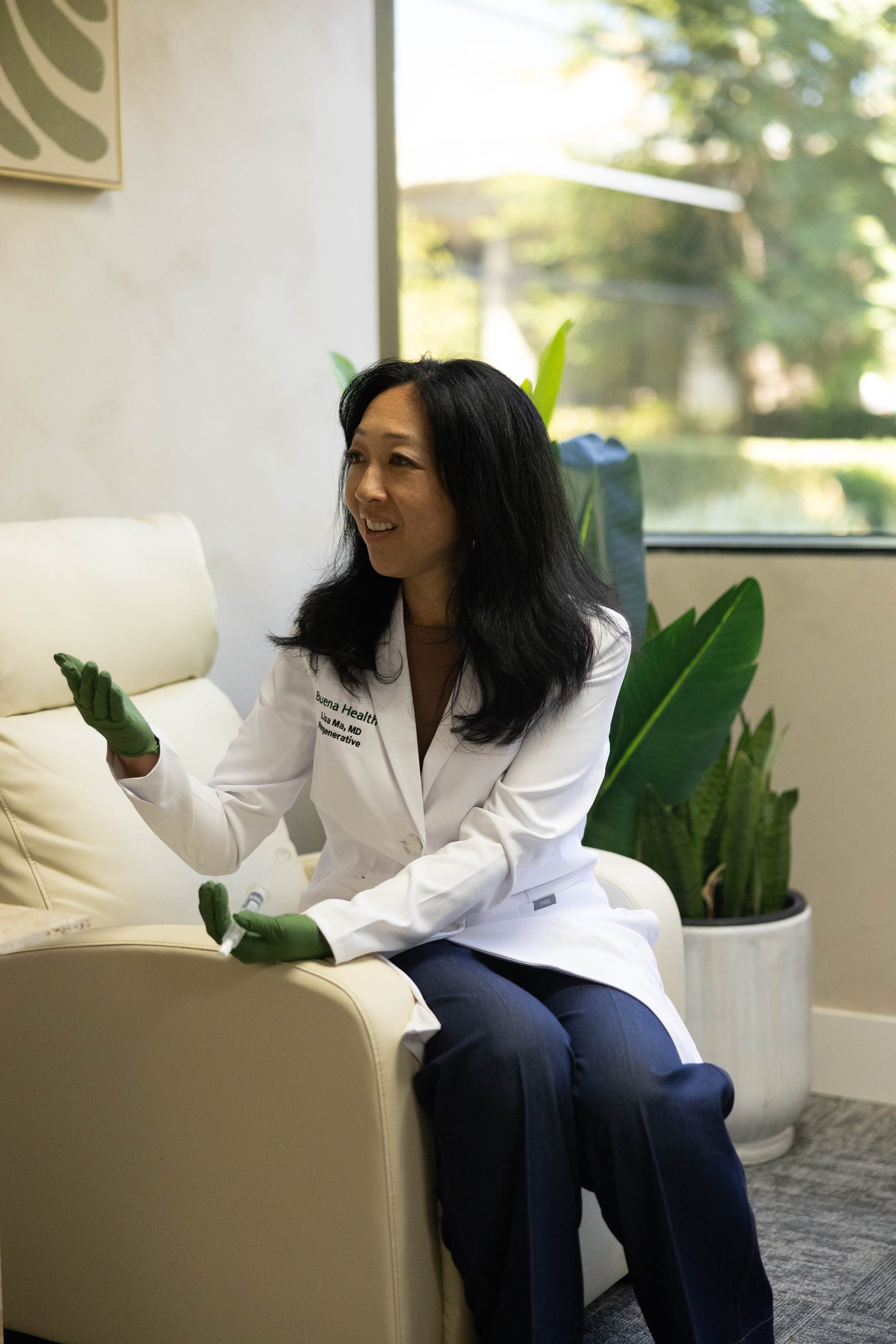 Dr. Lisa Ma talking through a treatment plan in a sunlit consultation corner